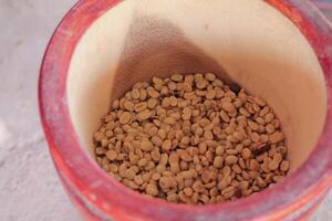 Farmers use wooden mortars and pestles to break the husks apart from the coffee beans to remove unwanted husks from coffee beans before processing them to produce high quality coffee beans for export. photo
