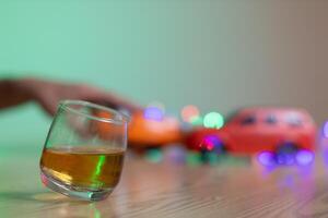 glass of alcohol is left on table after drinking with friends in office after work so that alcohol helps relax mind drinking alcohol in moderation and campaigning against drunk driving. photo