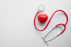Doctors use stethoscope to listen patient heartbeat to find faults in heart disease. Doctors use stethoscope to listen patient heart rate to gather information diagnose disease and provide treatment. photo