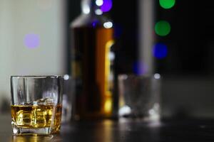 glass of alcohol is left on table after drinking with friends in office after work so that alcohol helps relax mind drinking alcohol in moderation and campaigning against drunk driving. photo