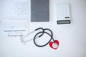 Doctors use stethoscope to listen patient heartbeat to find faults in heart disease. Doctors use stethoscope to listen patient heart rate to gather information diagnose disease and provide treatment. photo
