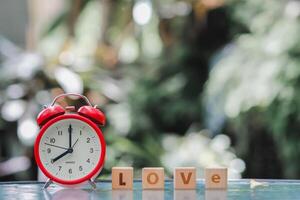 wooden blocks with word love are arranged to indicate meaning I love you and are also symbol of love and friendship for one another. Wooden blocks with word love are arranged on glass table. photo