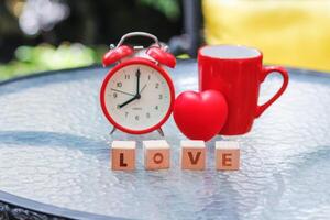 wooden blocks with word love are arranged to indicate meaning I love you and are also symbol of love and friendship for one another. Wooden blocks with word love are arranged on glass table. photo