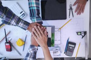 Businessmen and investors join hands after meeting and successfully agreeing on contract invest in real estate. Symbolic concept of touching hands touching hands together show cooperation and promise. photo