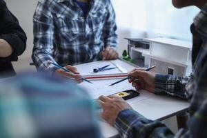 engineering is currently discussing structural design issues with architects to review plans to suit construction and stability of building. concept joint consultation between engineers and architects photo