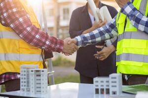 Engineers are reviewing plans from architects to prepare to install solar panels and wind turbines on the building to efficiently produce electricity using the concept of green energy from solar cells photo