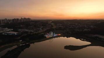 Curitiba in Parana, Brazil. Aerial View. Wonderful sunset with views of buildings and Tangua Park. Lake with reflection. video