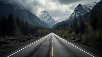 an empty road in the mountains with trees and mountains photo