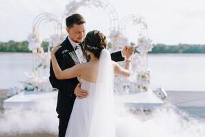 the first dance of the bride and groom inside a restaurant photo