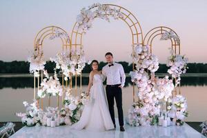 bride and groom against the backdrop of a yellow sunset photo