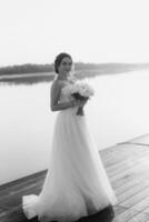 bride against the background of a yellow sunset photo