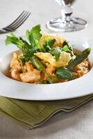 Asparagus risotto with pirarucu fish and fried cassava chips photo