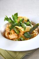 Asparagus risotto with pirarucu fish and fried cassava chips photo
