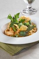 Asparagus risotto with pirarucu fish and fried cassava chips photo