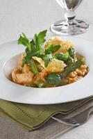 Asparagus risotto with pirarucu fish and fried cassava chips photo