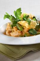 Asparagus risotto with pirarucu fish and fried cassava chips photo