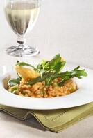 Asparagus risotto with pirarucu fish and fried cassava chips photo