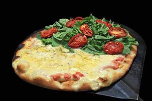 Brazilian pizza with each half with different flavors and toppings coming out of the oven photo