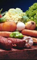 vegetables, salami, garlic, carrots and egg on wooden table photo
