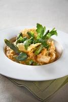 Asparagus risotto with pirarucu fish and fried cassava chips photo