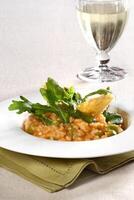 Asparagus risotto with pirarucu fish and fried cassava chips photo
