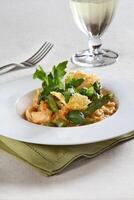 Asparagus risotto with pirarucu fish and fried cassava chips photo