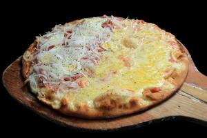 Brazilian pizza with each half with different flavors and toppings coming out of the oven photo