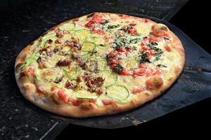 Brazilian pizza with each half with different flavors and toppings coming out of the oven photo