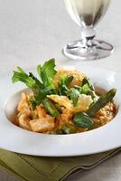 Asparagus risotto with pirarucu fish and fried cassava chips photo
