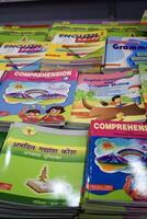 New Delhi, India, February 17 2024 - Variety of Books on shelf inside a book-stall at Delhi International Book Fair, Selection of books on display in Annual Book Fair at Bharat Mandapam complex photo