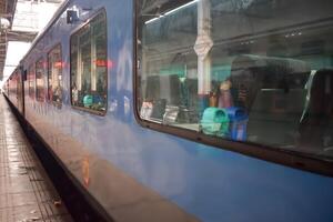 Delhi, India, June 09 2024 - Indian railway express train at departure from Anand Vihar railway station during morning time, Colourful Express train at Delhi railway station photo