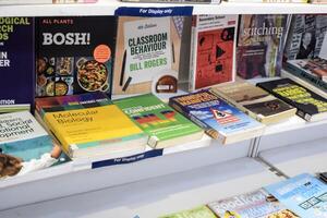 New Delhi, India, February 17 2024 - Variety of Books on shelf inside a book-stall at Delhi International Book Fair, Selection of books on display in Annual Book Fair at Bharat Mandapam complex photo