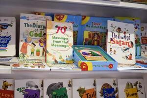 New Delhi, India, June 25 2024 - Variety of Books on shelf inside a book-stall at Delhi International Book Fair, Selection of books on display in Annual Book Fair at Bharat Mandapam complex photo