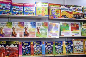 New Delhi, India, June 25 2024 - Variety of Books on shelf inside a book-stall at Delhi International Book Fair, Selection of books on display in Annual Book Fair at Bharat Mandapam complex photo