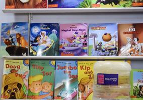 New Delhi, India, June 17 2024 - Variety of Books on shelf inside a book-stall at Delhi International Book Fair, Selection of books on display in Annual Book Fair at Bharat Mandapam complex photo