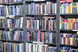 New Delhi, India, June 17 2024 - Variety of Books on shelf inside a book-stall at Delhi International Book Fair, Selection of books on display in Annual Book Fair at Bharat Mandapam complex photo