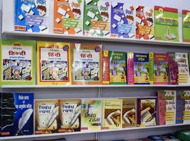 New Delhi, India, June 17 2024 - Variety of Books on shelf inside a book-stall at Delhi International Book Fair, Selection of books on display in Annual Book Fair at Bharat Mandapam complex photo
