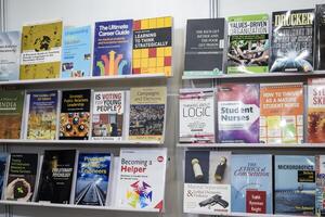 New Delhi, India, June 17 2024 - Variety of Books on shelf inside a book-stall at Delhi International Book Fair, Selection of books on display in Annual Book Fair at Bharat Mandapam complex photo