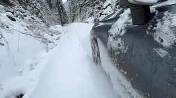 Powerful SUV vehicle struggling to maintain traction and control on the winter country road with fresh snow video