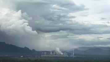 The pipe cooling tower emits an industrial white steam, creating a conceptual environment photo