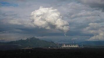 The pipe cooling tower emits an industrial white steam, creating a conceptual environment photo