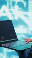 Vertical System administrator solving tasks on laptop, running artificial intelligence programming scripts. Close up shot of technician manipulating lines of code for AI applications development, camera A video