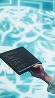 Vertical Engineer uses tablet and AI deep neural networks modeled after human brain to solve complex problems. Close up of admin using machine learning model to look at data and better complete tasks, camera B video