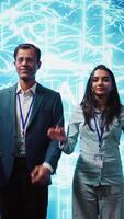Vertical Portrait of cheerful team of admins using artificial intelligence computing simulating human brain. Smiling colleagues working with AI machine learning algorithms, camera B video
