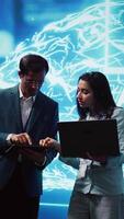 Vertical Teamworking colleagues using AI neural networks modeled after human brain to solve complex problems. Team of IT specialists using deep learning to look at data and complete tasks, camera B video