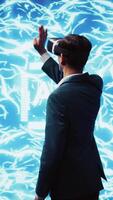 Vertical Computer scientist wearing VR headset looking at hologram of artificial intelligence human brain simulation. Indian man interacting with AI visualization showing machine learning algorithms, camera B video