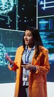 Vertical Speaker talking with audience on stage at AI conference bringing together leading experts and researchers to explore latest developments in artificial intelligence and machine learning, camera B video
