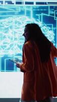 Vertical Happy speaker doing presentation at tech conference, explore ways emerging AI technologies can positively enhance companies workforce. Presenter promoting artificial intelligence solutions, camera B video