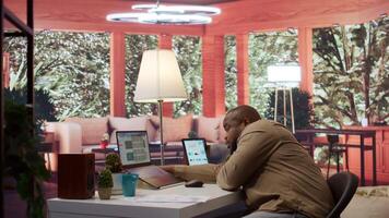 Entrepreneur falling asleep while he is calculating the annual sales reports to review the budget, feeling exhausted and fatigued working from home. Businessman with burnout. Camera B. video