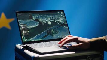 European Union using radar system on laptop to detect incoming ballistic missiles attacking member states. EU alliance army soldier scanning rockets approaching countries, deploying shields, camera A video